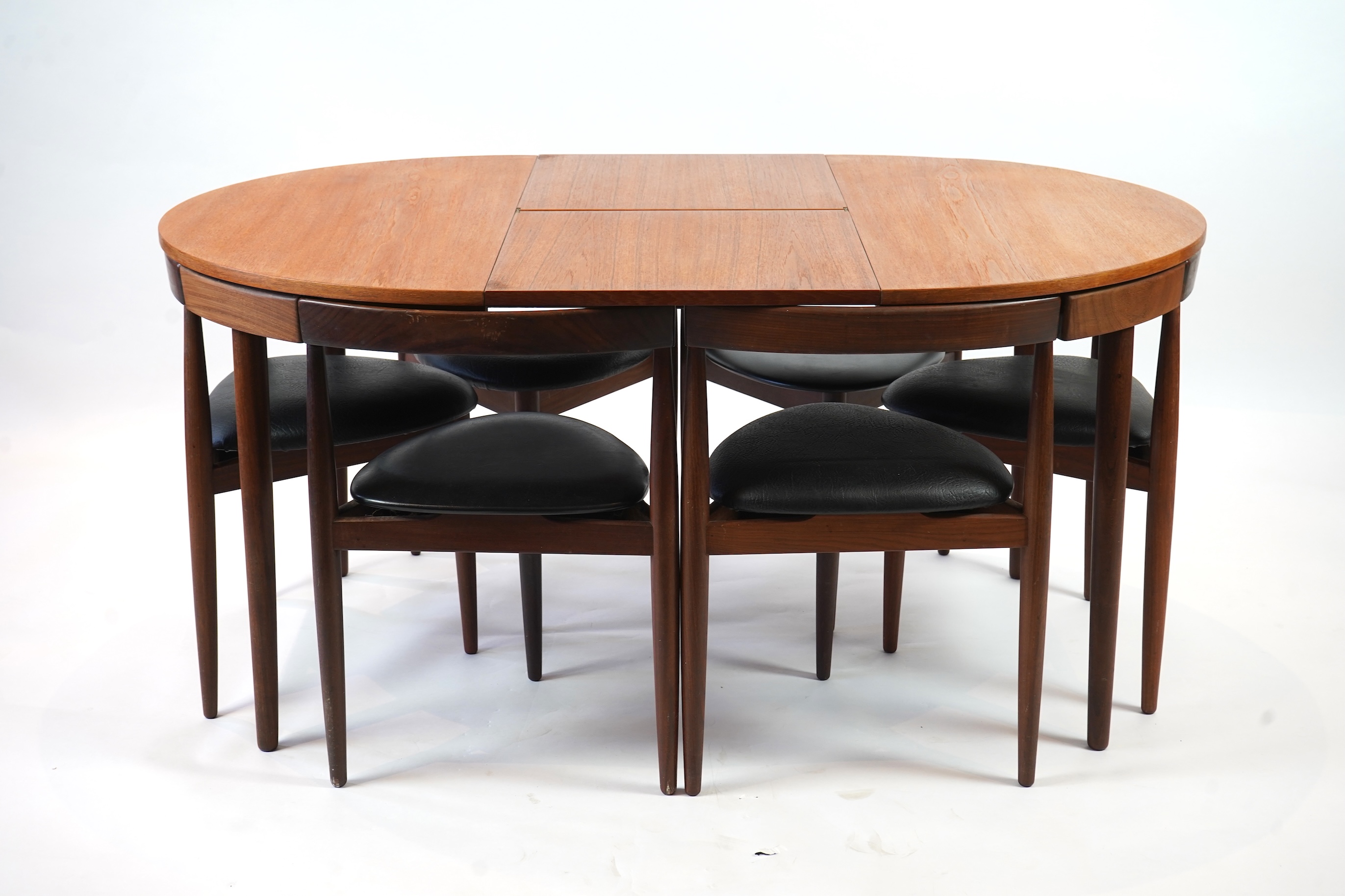 Hans Olsen (Danish, 1919–1992) for Frem Røjle: A Danish teak 'Roundette' extending dining table and six chairs